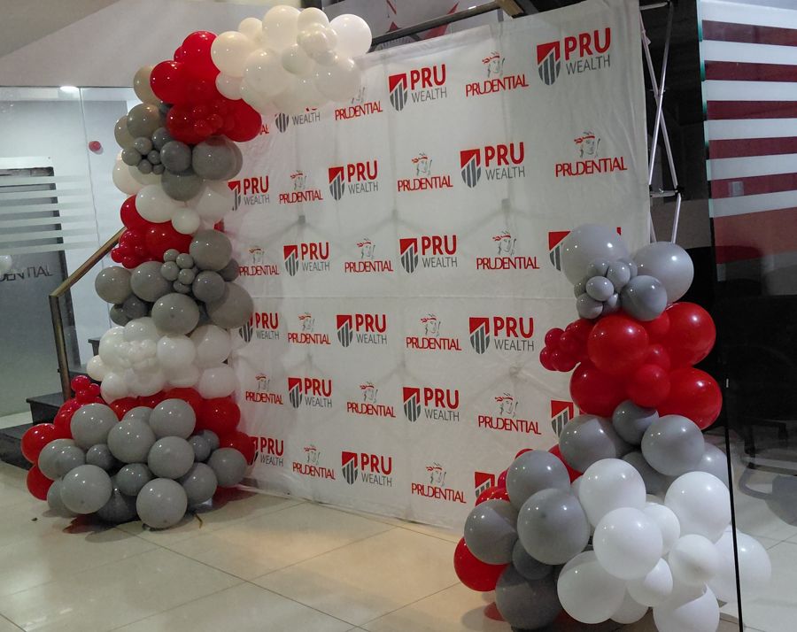 Branded backdrop with red, grey and white balloon garlands