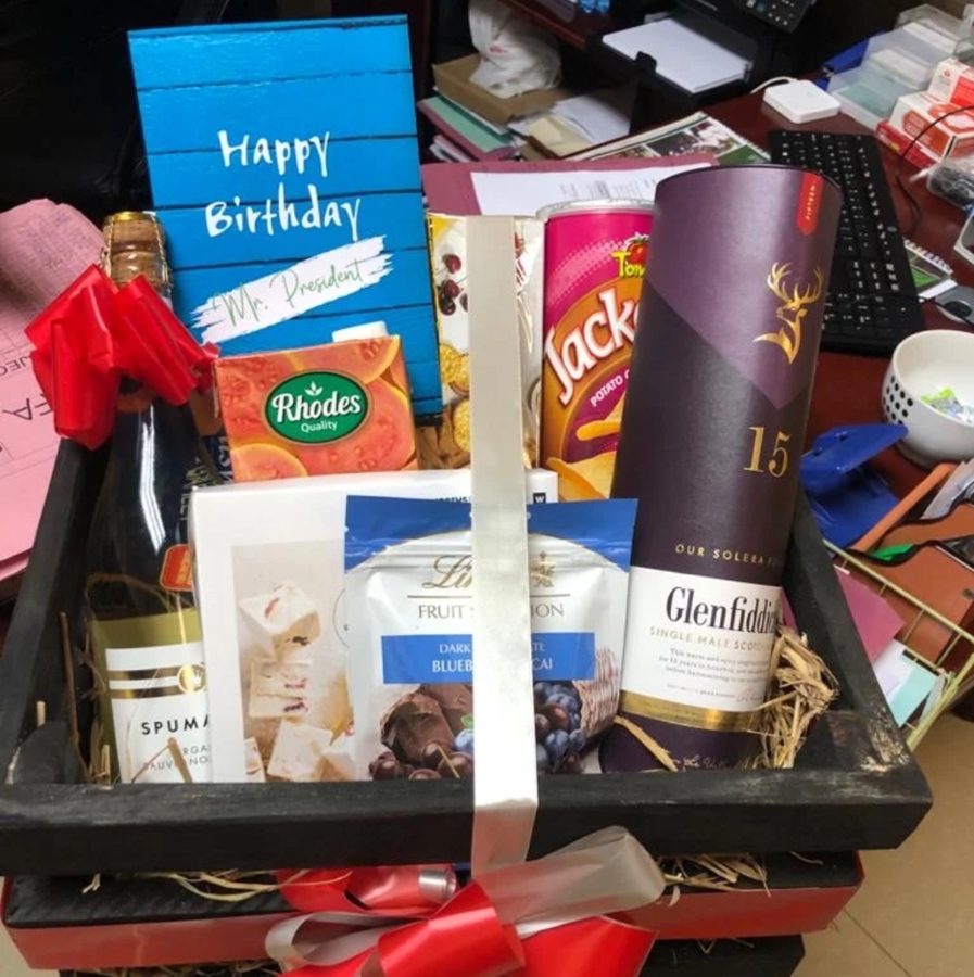 Wooden crate birthday hamper with single malt whisky, sparkling wine, chocolates, crisps and a Happy Birthday card