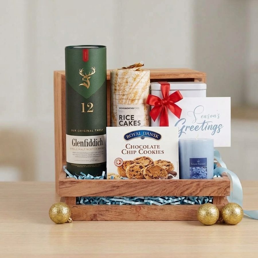 Wooden crate hamper with single malt whisky, rice cakes, cookies, a candle and a Season's Greetings card