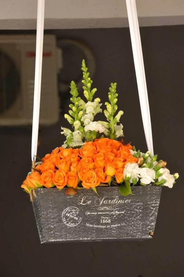 Hanging garden box of orange roses