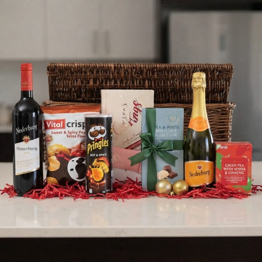 Wicker basket hamper with red wine, sparkling wine, chocolates, crisps and tea