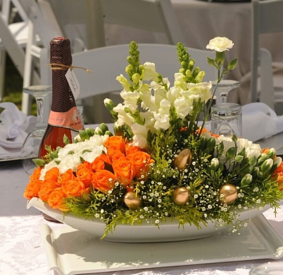 Orange rose and white snapdragon table centrepiece